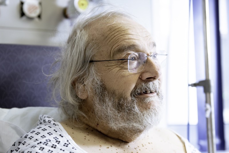 NHS patient - old man with grey hair and beard with glasses